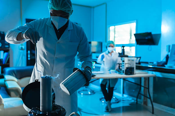 Scientist in protective gear works with liquid nitrogen in agricultural laboratory, conducting sperm storage in biotechnology lab, ensure quality control in cattle breeding programs.