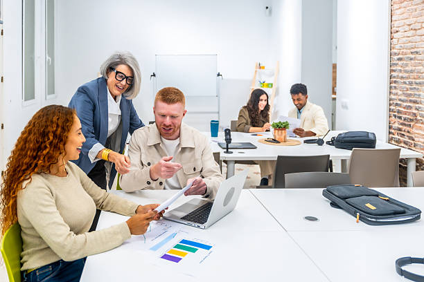 istock Colleagues collaborating on business document during startup meeting 2238689993