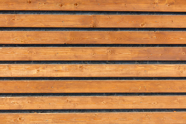 A wooden board with black stripes. The board is brown in color. The board is made of wood
