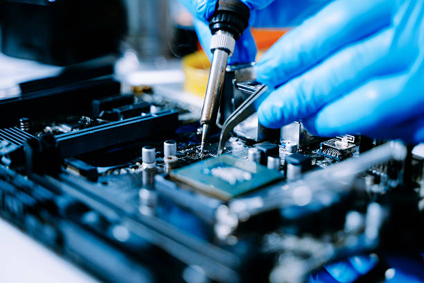 istock Closeup of expert soldering a green PCB board using precision tools. Ideal for electronics, circuit repair, engineering, tech 2238693364
