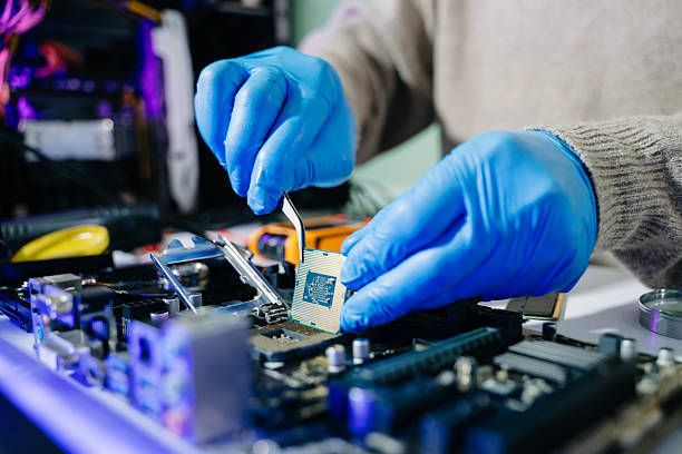 istock The technician is putting the CPU on the socket of the computer motherboard. electronic engineering electronic repair, electronics measuring 2238693385