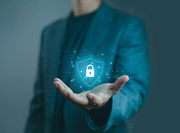 istock Businessman hand holding digital shield with padlock icon, representing cybersecurity, data protection, secure network, online privacy, encryption, and modern information technology security. 2238694495