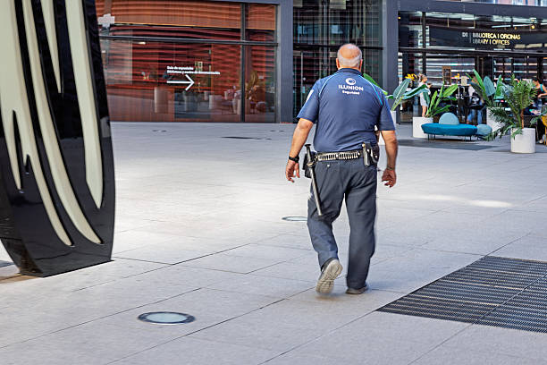 Auckland, New Zealand - November 4, 2015: A New Zealand police officer walks in a crowd of people. With over 11, 000 staff New Zealand police is the largest law enforcement agency in New Zealand