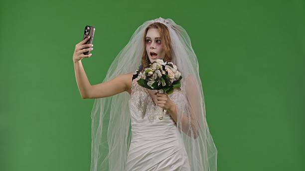 istock Dead Bride in a Wedding Dress on a Green Background 2238697569