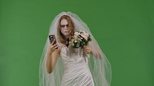 istock Dead Bride in a Wedding Dress on a Green Background 2238697733