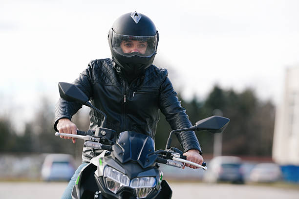 istock Man Wearing a Helmet Riding a Motorcycle with Determined Look in Outdoor Setting 2238697874