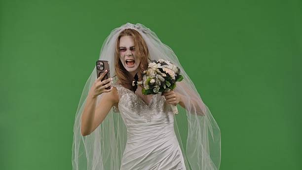 istock Dead Bride in a Wedding Dress on a Green Background 2238697893
