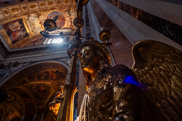 Majestic golden angel sculpture holding a candelabra, illuminated by natural light within a richly decorated and historic cathedral interior.
