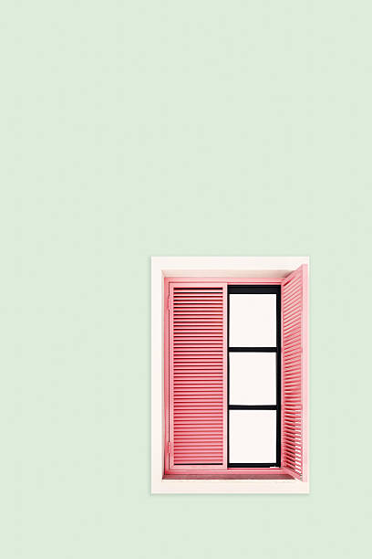 istock Minimal summer aesthetic pink shutter window on pastel mint green wall. Natural sunlight creates soft shadows, modern design. Concepts of summer, vacation, tropical style, architecture, home decor 2238702406