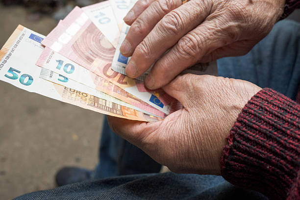 istock Euro banknotes in the hands of a senior. 2238708227