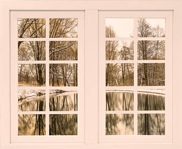 Winter landscape seen through large glass doors, showcasing a serene frozen lake and snow-covered forest. Tranquil and picturesque scene perfect for winter themes.