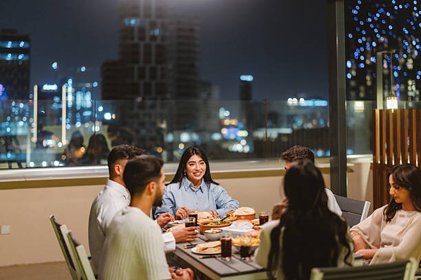 istock Young Arabic Group Enjoying Rooftop Dinner with Riyadh Skyline 2238708654