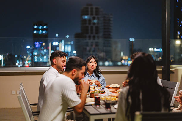 istock Young Arabic Group Enjoying Rooftop Dinner Overlooking Riyadh at Night 2238708681