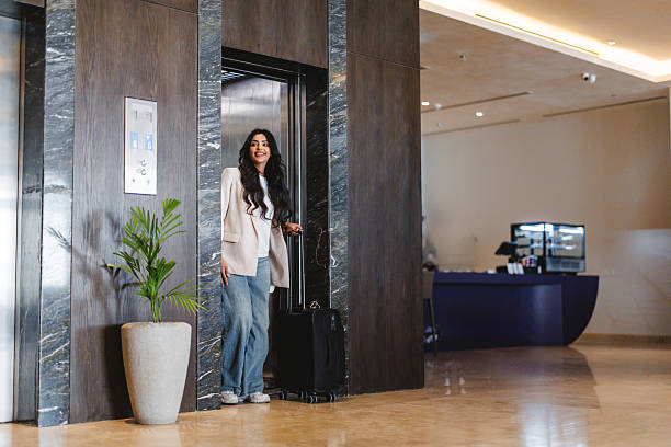 istock Arabic Businesswoman Exiting Hotel Elevator with Luggage 2238709483
