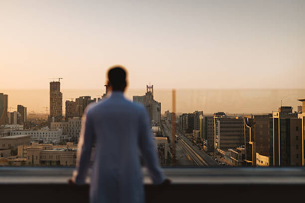 istock Young Arabic Male Observing Riyadh Skyline From Rooftop 2238709812