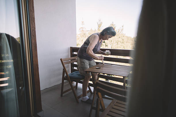istock Woman using brush for oiling wooden table 2238709834