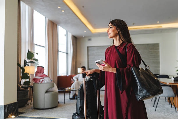 istock Confident Mid Adult Middle Eastern Female Using Smartphone in Hotel Lobby 2238710003