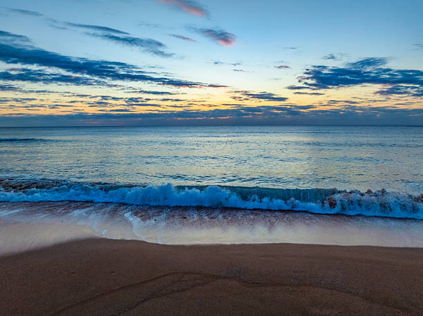 Sunrise Seascape with calm seas where the Pacific meets the shore at Newport on the Northern Beaches of Sydney, NSW, Australia.