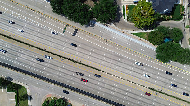 istock Dense traffic on US 75 highway dominates frame with directional lanes, congestion, buffered by landscaped zones, sound barriers, adjacent to upscale homes, tree-lined streets in University Park 2238711355