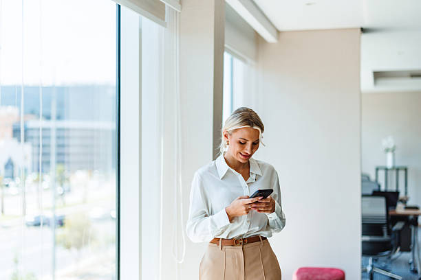 istock Confident Caucasian Businesswoman Using Smartphone in Modern Office 2238711516