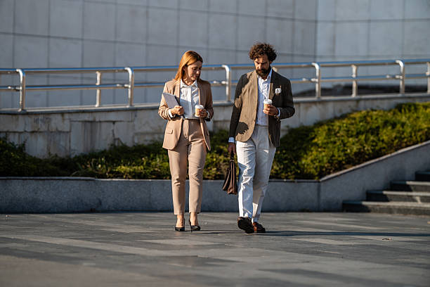 istock Business people walking and talking outdoors during coffee break 2238713229