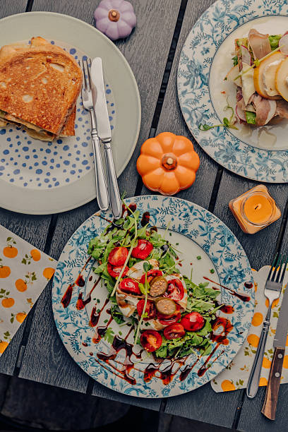 istock Sandwich with tomato and fish on a blue plate autumn vibe 2238713828