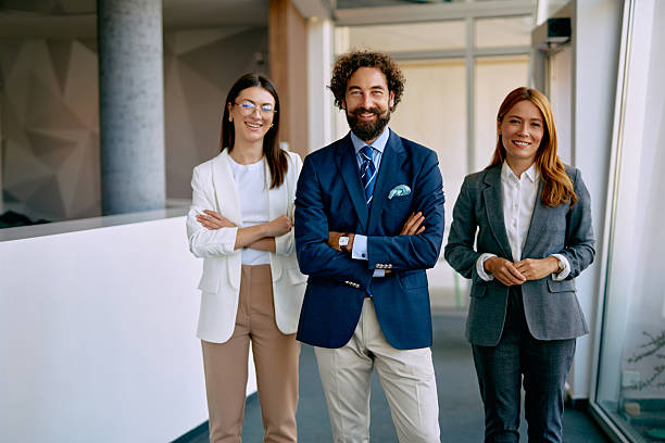 istock Business professionals standing in office hallway smiling at camera 2238714080