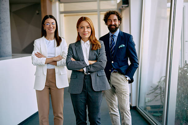 istock Business professionals standing in office looking at camera 2238714095