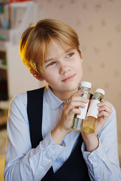 istock Young person holding aroma diffuser liquids at home in cozy setting 2238723493