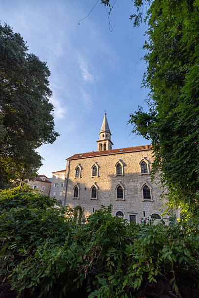 istock Historic Stone Church with Steeple and Greenery 2238723553