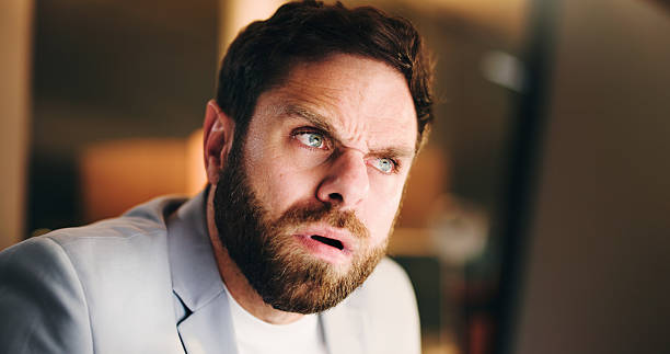 istock Thinking, confused and business man with computer for financial mistake, error 404 or night. Deadline, reading or serious advisor with stress for investment glitch, doubt or problem solving in office 2238730528