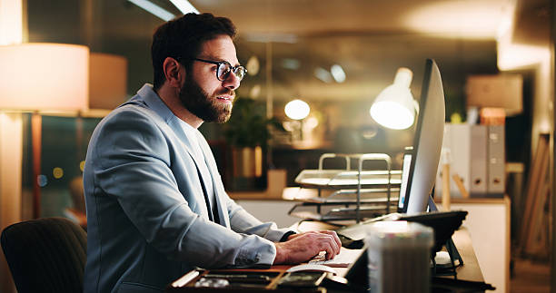 istock Night, worry or businessman in office with computer, typing report or reading document for presentation. Overtime, stressed or person with monitor in workplace, deadline or pressure in finance risk 2238730564