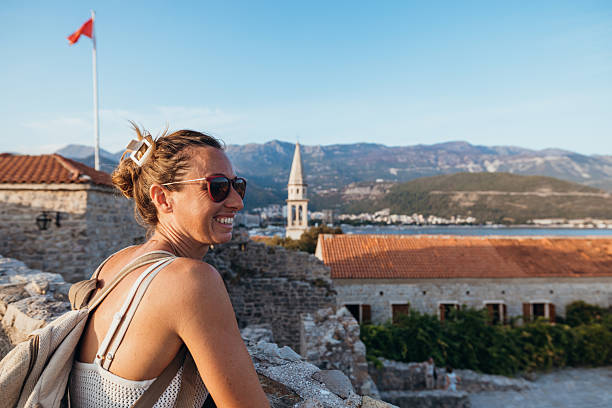 istock Woman Smiling While Sightseeing Historic Town 2238730892