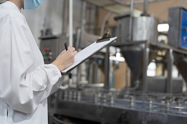 istock Factory worker working in canned fish factory production line, checking quality of cans while transporting on conveyor belt. Canned fish factory, seafood manufacturing and processing 2238731896
