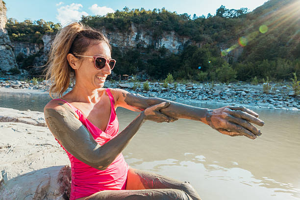 woman covered by mud crossing the canal