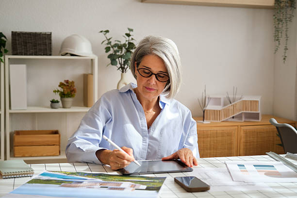 istock Senior female architect working on digital tablet at home office 2238737111