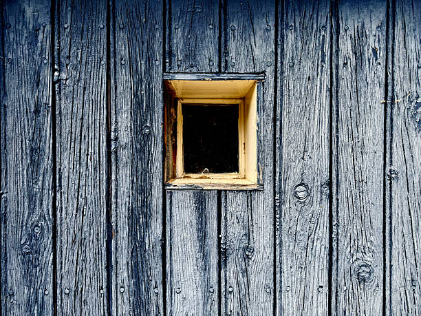 Small window in a wooden shed door