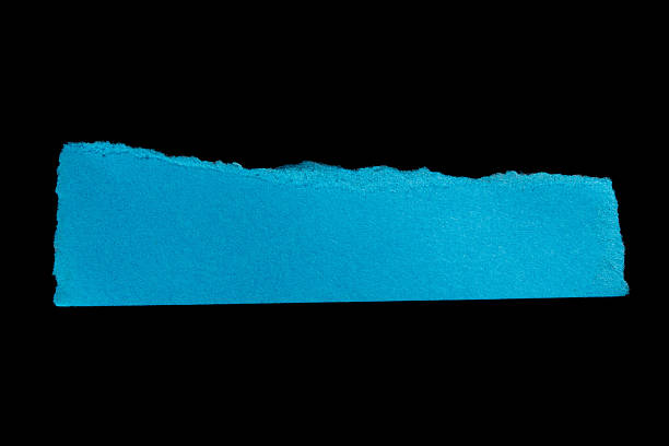istock Blue torn paper piece on isolated black background 2238737501