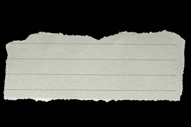 istock Piece of ripped torn lined paper on black background 2238737702