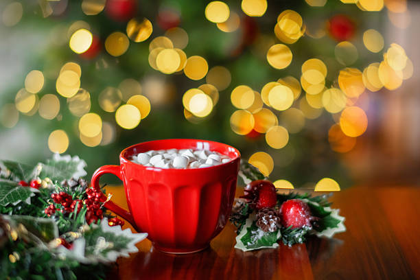 A mug with hot chocolate and marshmallow on a table
