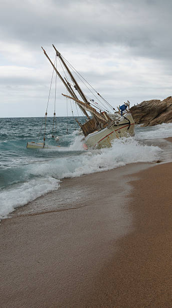 istock A deserted and stranded boat rests on a sandy shoreline beneath a gloomy and overcast sky 2238740797