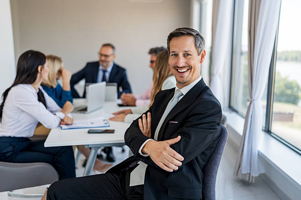 istock Smiling businessman looking at camera during office meeting 2238740816