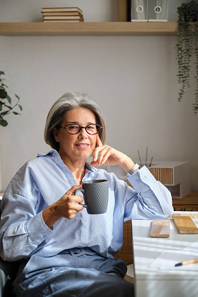 istock Mature female architect smiling and holding coffee mug 2238740897
