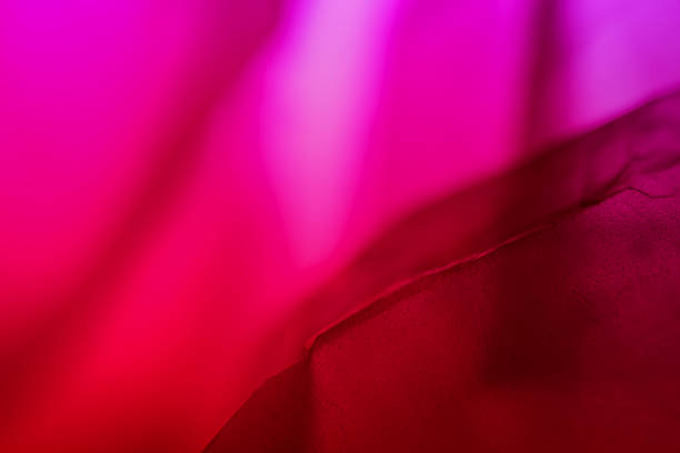 Extreme close up of red empty plastic bag background. The plastic surface is wrinkly and tattered making abstract pattern. Selective focus, shallow depth of field.