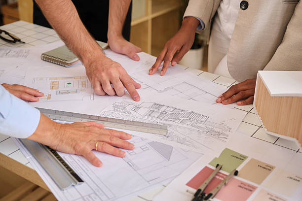 istock Architects collaborating on building blueprint design and planning 2238742223