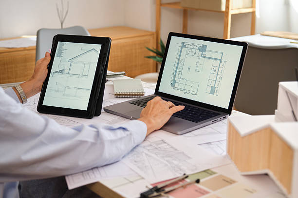 istock Architect designing building plans with laptop and digital tablet 2238742400