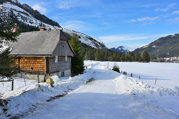 Peaceful mountain cabin in serene winter morning at the starting point of some popular winter ski tours. Styria, Austria.