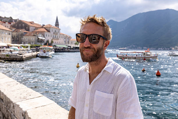 istock Man Relaxing by Waterfront in Sunny Coastal Town 2238743515