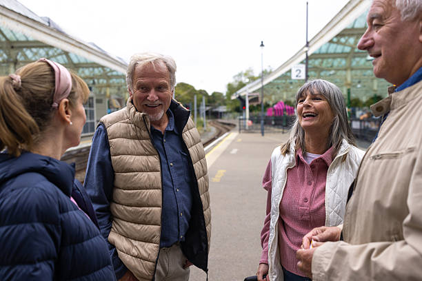 istock Mature Friends Laughing on the Railway Station Platform 2238744688
