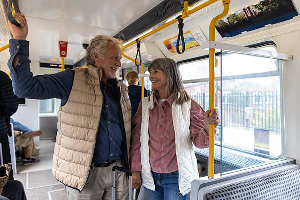 istock Smiling Couple Standing on a Metro Train 2238744762